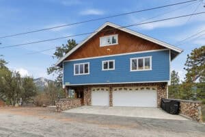 Front exterior of Edgar's Hideaway with garage and mountain setting